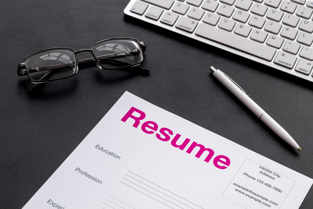 A professional CV creation document on a desk next to a pen and keyboard