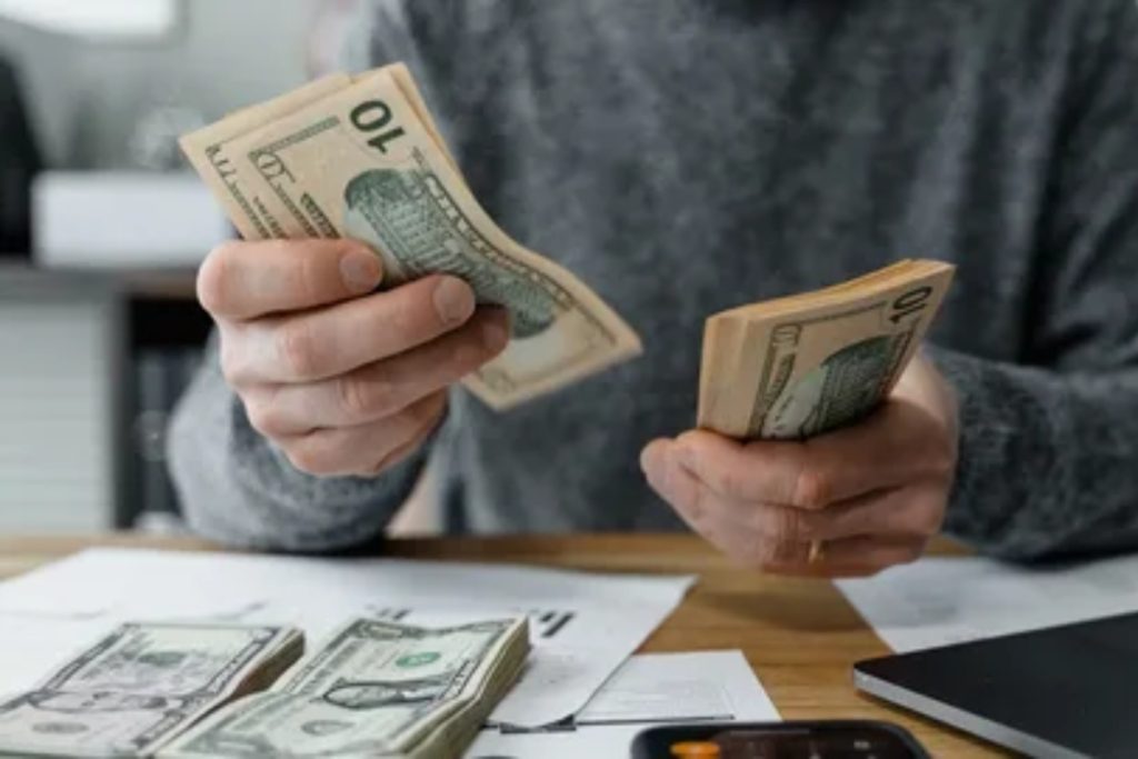 Employee reviewing a gross salary breakdown showing basic pay, allowances, and deductions on a payslip